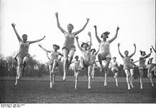 Students at a boarding school in Hanover, beginning each day with 8 o'clock rhythmic dancing and jumping exercises, 1931. Bundesarchiv Bild 102-11617, Hannover, Schulerinnen der Logis-Schule.jpg