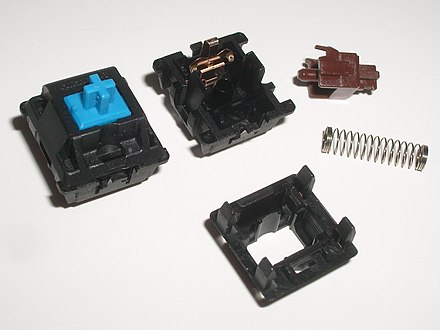 Two Cherry MX Mechanical Keyboard Switches (Clicky on the left and a disassembled tactile on the right)