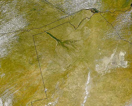 The Okavango Delta (centre) of southern Africa, where the Okavango River spills out into the empty trough of the Kalahari Desert. The area was a lake fed by the river during the Ice Ages (national borders are superimposed)