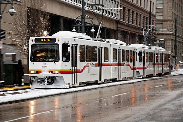 Image: Denver LR Vs in snow, on Stout St in downtown