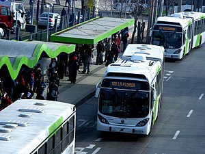 Articulated bus pulling out of a station