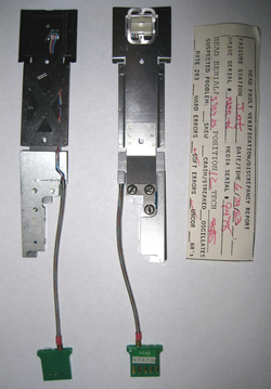 Drive heads from the HP 7935 with assembly reject tag circa 1983 HP7935 disc drive heads circa 1983.png