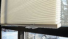 Cellular shades, also called honeycomb shades, hanging in a window. Honeycomb or cellular window shades.jpg