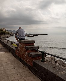 Man sitting at the promenade, Salermo, Italy