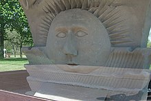 A Sunstone from the original Nauvoo Temple in a case in front of The Church of Jesus Christ of Latter-day Saints Visitor Center in Nauvoo, Illinois Nauvoo Temple Sunstone 2003.jpg