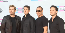 Canadian rock band Nickelback earned their first and only number one single with "How You Remind Me". It went on to be the best-charting song of 2002. Nickelback AMAs 2011.png