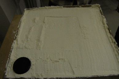 Analogue model of caldera formation using flour to represent the upper part of the crust and a balloon to represent the inflating magma chamber Origin of volcanic caldera via analogue model.gif