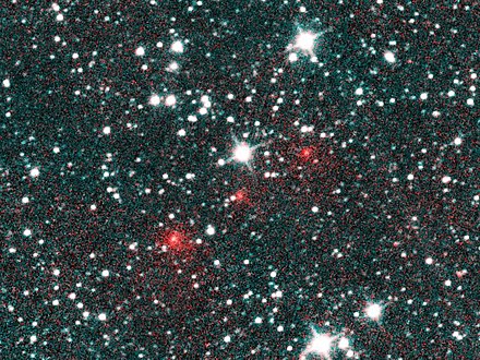 Discovery image. The comet appears as three fuzzy red dots in this composite of three infrared images taken by NEOWISE on March 27, 2020.