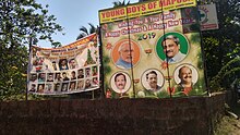 Parrikar, Goa's former CM, looms large over a BJP placard in the locality. Parrikar, Goa's former CM, looms large over a BJP campaign placard 01 (Parra).jpg