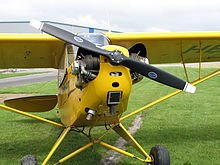 A Piper J3C-65 front view showing eyebrow air scoops on its engine cylinders