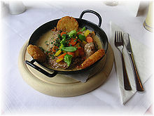 A traditional Austrian pork dish, served with potato croquettes, vegetables, mushrooms and gravy. Pork .JPG