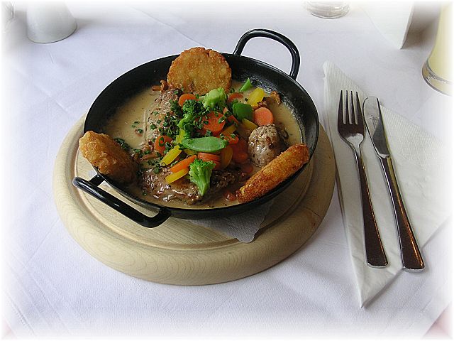 A traditional Austrian pork dish, served with potato croquettes, vegetables, mushrooms and gravy.