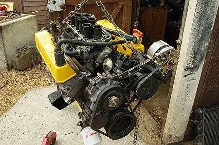 A V8 engine hanging in chains from an engine crane Rover V8 engine.jpg