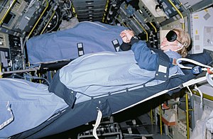 Mission Specialist Margaret Rhea Seddon, wearing a blindfold, sleeps in SLS-1 module (STS-40) STS040-31-020 - STS-40 MS Seddon, wearing blindfold, sleeps in SLS-1 module.jpg