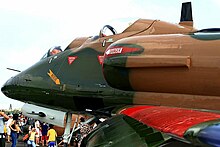 Stepped cockpit layout of a TA-4SU (900). The row of vortex generators on the drooped leading edge slats and the ram-air intake mounted on the portside for engine cooling, are unique to the TA-4SU. The chrome-plated muzzle brake of the Colt Mk.12 cannon is also visible. TA-4SU Skyhawk cockpits.jpg