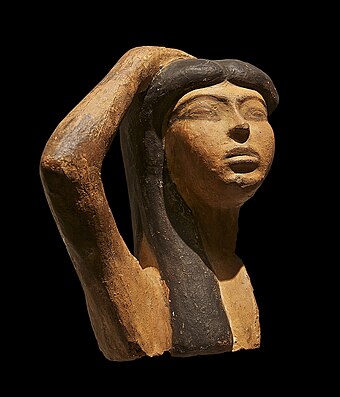 A rare sample of Egyptian terra cotta sculpture which may depict Isis mourning Osiris. The sculpture portrays a woman raising her right arm over her head, a typical gesture of mourning. Musée du Louvre, Paris.
