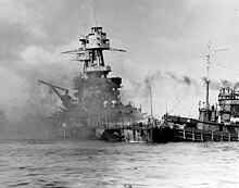 Hoga pushes the sinking USS Nevada to safety in soft sand after the attack on Pearl Harbor. USS Nevada 2nd grounding off Waipio Point Nara 80-G-33020.jpg