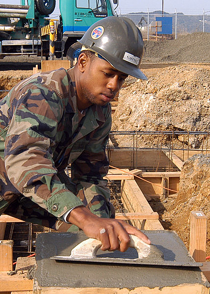 File:US Navy 050321-N-2385R-005 Engineering Aide Constructionman Doug Gaffney, assigned to Naval Mobile Construction Battalion Four Zero (NMCB-40), Detachment Sasebo, uses a magnesium float to even out concrete.jpg