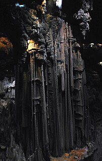 Stalagnate column from the ceiling to the floor of a limestone cave