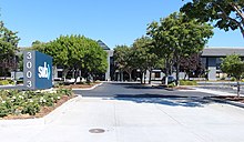 An entrance to a commercial park with the Silicon Valley Bank logo on a sign.
