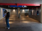 A guy is looking at his cellphone in the concrete architecture of the metro entrance underground Waterlooplein; free Amsterdam photo by Fons Heijnsbroek, 27 March 2022