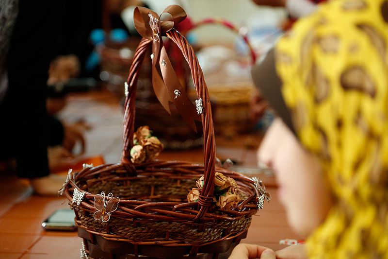 File:A teenage Syrian refugee girl looks at her work after decorating a wicker basket at a project in Lebanon supported by UK aid (14679661211).jpg