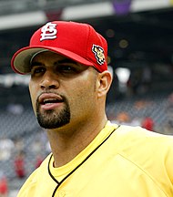 A man in a yellow shirt and a red baseball cap