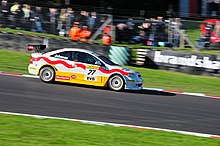 Johnson driving the Boulevard Team Racing Vauxhall Astra Coupe at Brands Hatch during the 2010 British Touring Car Championship season. BTCC Brands Hatch October 2010 DSC 9584 (5068832793).jpg
