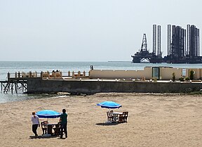 Beach with Oil Derrick in Baku Azerbaijan.jpg