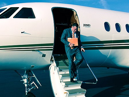 Butch Jones exiting plane.jpg