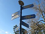 The Cheltenham Twinning Fingerpost at the Township building points to all other Cheltenhams throughout the World.