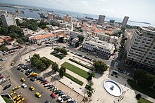 Dakar, Senegal's place de l'Independance: a center of government, banking and trade. In the background is the commercial port and the tourist area, Goree island. Dakar-Independance.jpg