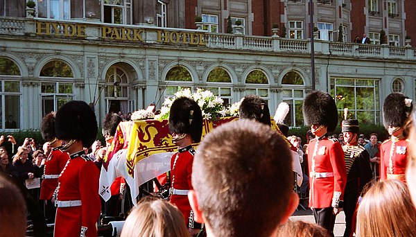 Diana's coffin borne through the streets of London on its way to Westminster Abbey. Her coffin was draped in a pall depicting the royal standard with 