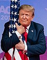 Donald Trump detail on 2 March 2019, from- President Donald J. Trump embraces the American flag at CPAC 2019 (cropped).jpg
