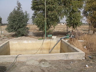 Irrigation water is pumped from this tank which stores effluent received from a constructed wetland in Haran-Al-Awamied, Syria. Effluent storage tank from where treated effluent is pumped away for irrigation (3232428204).jpg