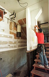 This central vacuum power unit has been installed high on a basement wall to reduce risk of damage from flooding, but requiring a ladder for maintenance. FEMA - 285 - Hazard Mitigation - raised water heater.jpg