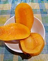 Fully ripe Chok Anan mango cut into three pieces.