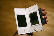 The "Guitar Grip", developed by Vicarious Visions for the Nintendo DS series Guitar Hero: On Tour provides four fret buttons for the game, while strumming is done on the DS touchscreen by use of a pick-shaped stylus. GuitarHero DSInterface.jpg