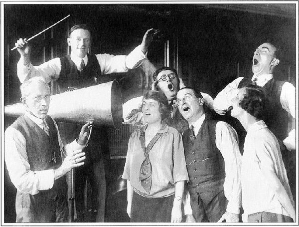 Conductor and cast members of the D'Oyly Carte Opera Company with acoustic recording horn at HMV, c. 1924