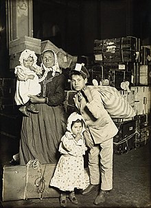 Italian family in the baggage room, 1905. Original caption:
Lost baggage is the cause of their worried expressions. At the height of immigration the entire first floor of the administration building was used to store baggage. Italian family in the baggage room, Ellis Island, 1905.jpg