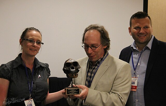 Krauss is given the Richard Dawkins Award by Mark W. Gura and Melissa Pugh of Atheist Alliance of America at the Reason Rally 2016.