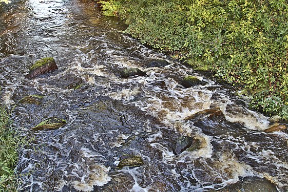 Lethe river flowing over a rapid in Wardenburg, Germany.