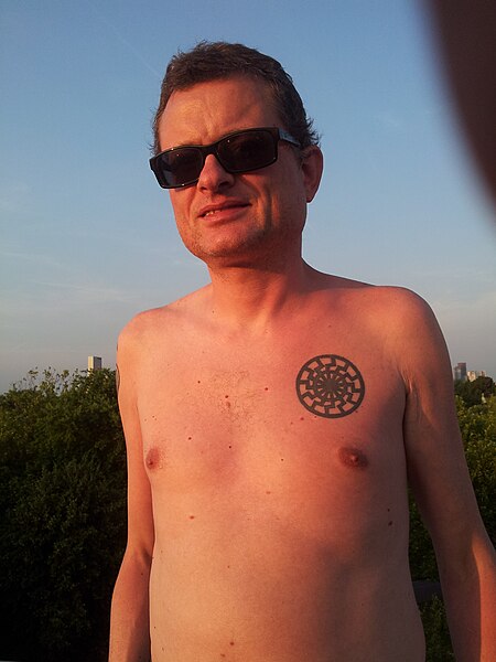 File:Man with black sun tattoo.jpg