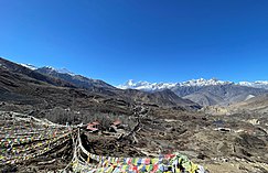 Muktinath Temple complex with Ranipauwa village in the middle background. In the far background are (centre) the Dhaulagiri Himal (8167 m) and (left) Nilgiri North Himal (7061 m) Muktinath Temple complex with Ranipauwa village in the immediate background. In the far background are (centre) the Dhaulagiri Himal (peak 8167 m) and (left) Nilgiri North Himal (peak 7061 m).jpg