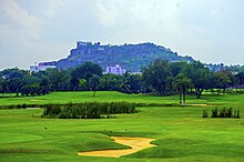 Golconda Fort towers above the golf course of Naya Qila Naya Qila 3.jpg