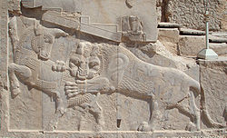 Bas-relief in Persepolis, a symbol of Iranian Nowruz: a bull (symbolizing the Earth) and lion (the Sun) in eternal combat are equal in power on the equinox. Nowruz Zoroastrian.jpg