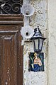 Old plaques and old lamp decorate entrance to typical maltese house by Renata Apan