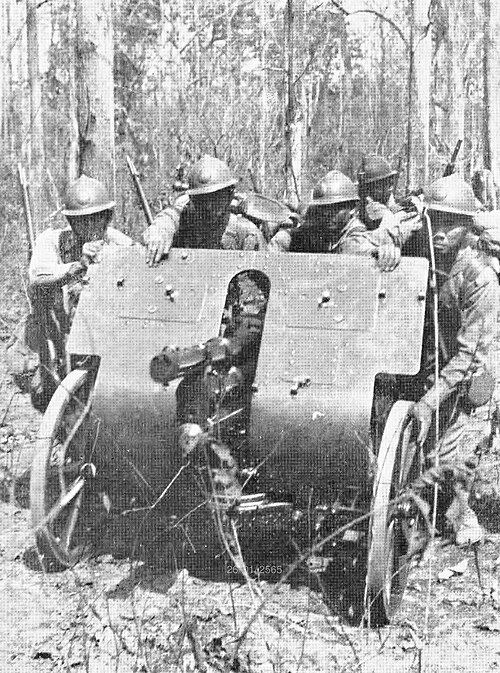 Thai Phayap Army soldiers wearing Adrian helmet, moving artillery in Burma, 1943.