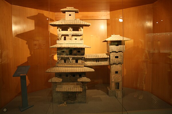 A Han Dynasty (202 BC – 220 AD) Chinese miniature model of two residential towers joined by a skyway