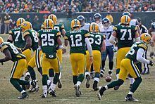 Green Bay Packers quarterback Aaron Rodgers (#12) breaks the Packers' offensive huddle. Quarterback Aaron Rodgers (12) and the Packers break the huddle..jpg